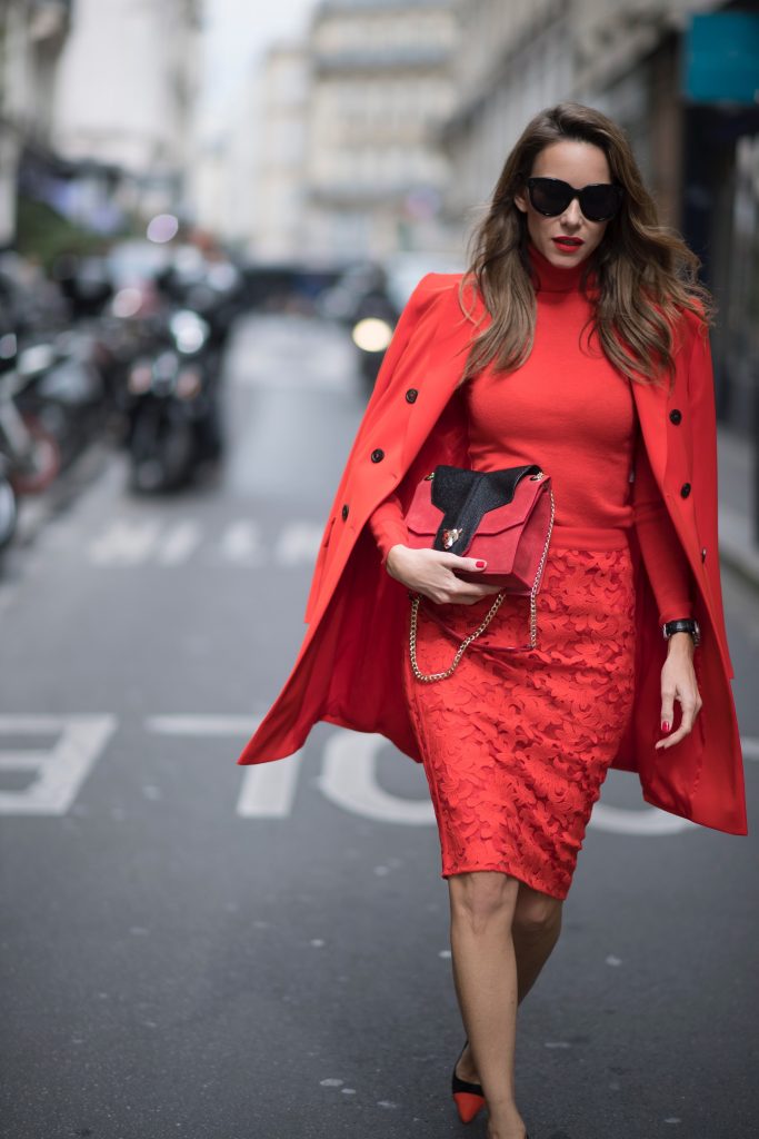 Alexandra Lapp seen wearing an orange outfit from Marc Cain, Manolo Blahnik heels in black with orange and Céline Audrey sunglasses, in the streets of Paris on September 27, 2017 in Paris, France.