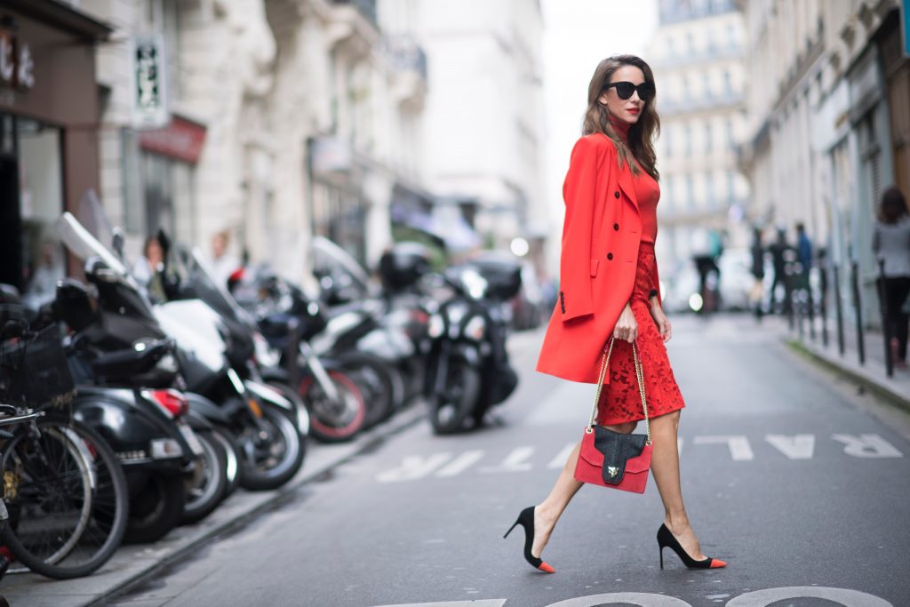 Alexandra Lapp seen wearing an orange outfit from Marc Cain, Manolo Blahnik heels in black with orange and Céline Audrey sunglasses, in the streets of Paris on September 27, 2017 in Paris, France.