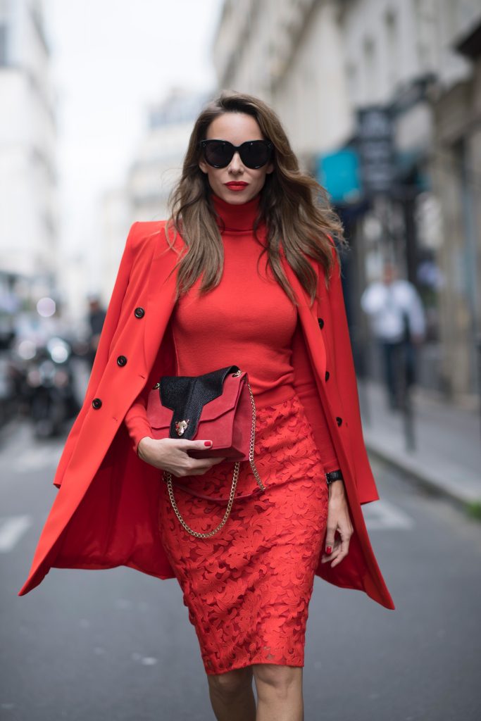 Alexandra Lapp seen wearing an orange outfit from Marc Cain, Manolo Blahnik heels in black with orange and Céline Audrey sunglasses, in the streets of Paris on September 27, 2017 in Paris, France.
