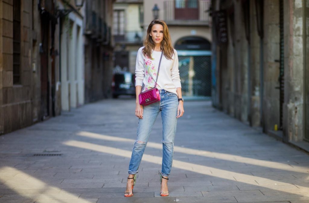 BARCELONA, SPAIN - NOVEMBER 29: Trench coat Hype in Barcelona, Alexandra Lapp wearing and beige oversized egg shaped Audrey trench coat from G-Lab, off-white round neck cashmere pullover with flower applications in pastel tones, vintage Leviss from Re Done, Sophia Webster Chiara sandal heels with a butterfly at the back and Chanel Boy bag in patent pink on November 29, 2017 in Barcelona, Spain.