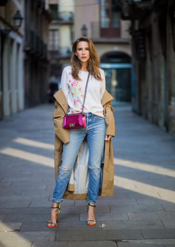 BARCELONA, SPAIN - NOVEMBER 29: Trench coat Hype in Barcelona, Alexandra Lapp wearing and beige oversized egg shaped Audrey trench coat from G-Lab, off-white round neck cashmere pullover with flower applications in pastel tones, vintage Leviss from Re Done, Sophia Webster Chiara sandal heels with a butterfly at the back and Chanel Boy bag in patent pink on November 29, 2017 in Barcelona, Spain.