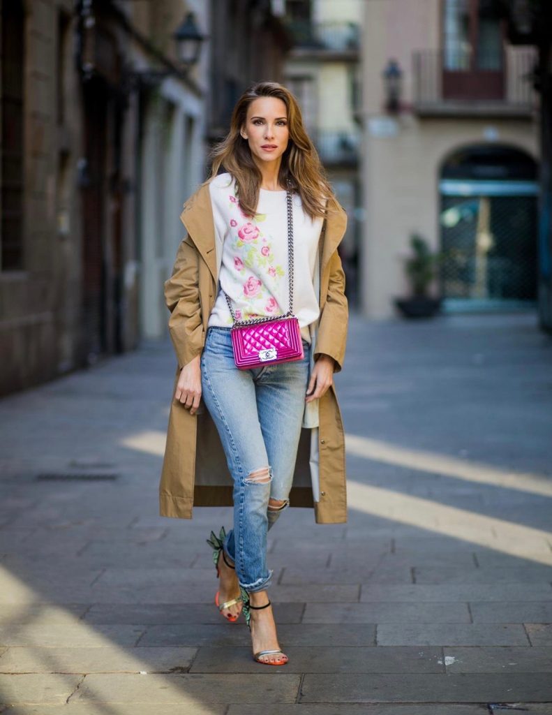 BARCELONA, SPAIN - NOVEMBER 29: Trench coat Hype in Barcelona, Alexandra Lapp wearing and beige oversized egg shaped Audrey trench coat from G-Lab, off-white round neck cashmere pullover with flower applications in pastel tones, vintage Leviss from Re Done, Sophia Webster Chiara sandal heels with a butterfly at the back and Chanel Boy bag in patent pink on November 29, 2017 in Barcelona, Spain.