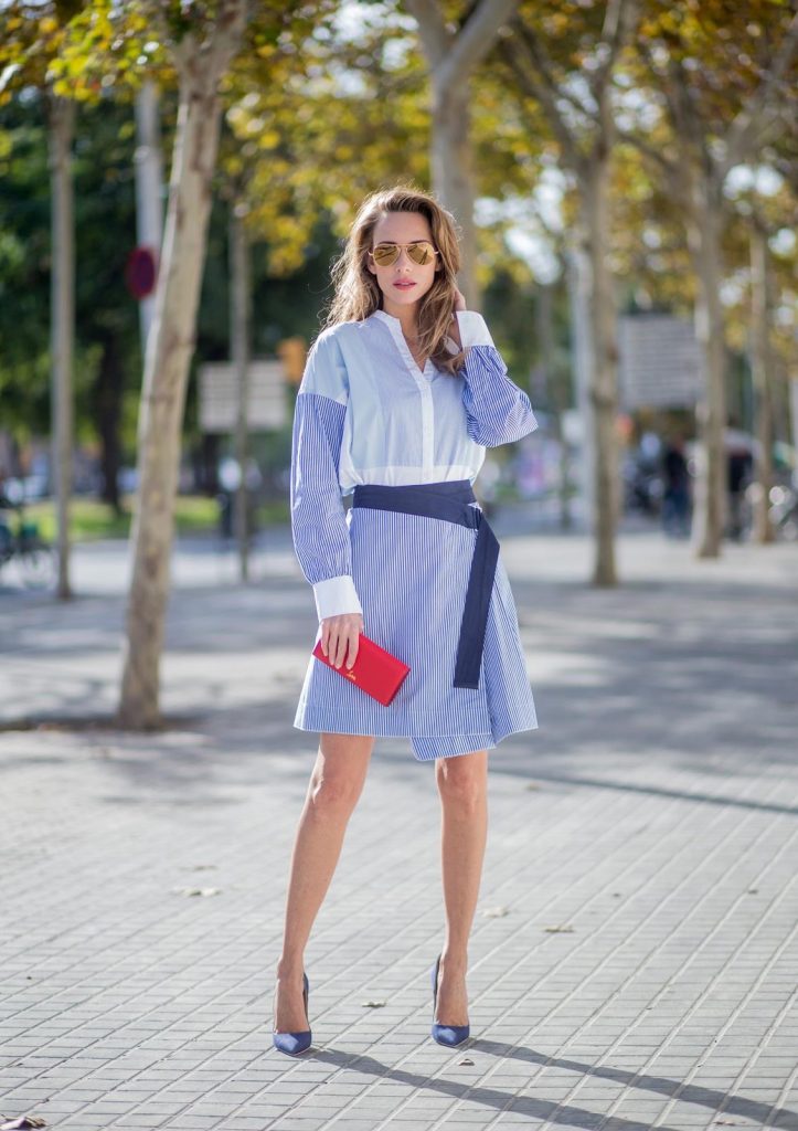 Steffen Schraut, Christian Louboutin, Ray Ban BARCELONA, SPAIN - NOVEMBER 27: Stripe Hype, Alexandra Lapp wearing a multi striped blouse with different stripes from Steffen Schraut, A-line skirt with blue and white stripes with a dark blue waist belt, So Kate pumps from Christian Louboutin in dark blue denim with a pink heel, red Christian Louboutin purse bag with golden chain, Aviator sunglasses in gold on November 27, 2017 in Barcelona, Spain.