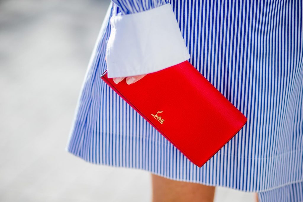 Steffen Schraut, Christian Louboutin, Ray Ban BARCELONA, SPAIN - NOVEMBER 27: Stripe Hype, Alexandra Lapp wearing a multi striped blouse with different stripes from Steffen Schraut, A-line skirt with blue and white stripes with a dark blue waist belt, So Kate pumps from Christian Louboutin in dark blue denim with a pink heel, red Christian Louboutin purse bag with golden chain, Aviator sunglasses in gold on November 27, 2017 in Barcelona, Spain.
