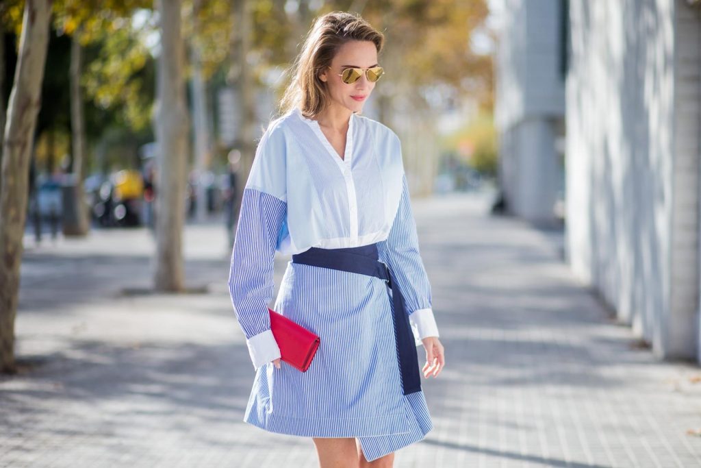 Steffen Schraut, Christian Louboutin, Ray Ban BARCELONA, SPAIN - NOVEMBER 27: Stripe Hype, Alexandra Lapp wearing a multi striped blouse with different stripes from Steffen Schraut, A-line skirt with blue and white stripes with a dark blue waist belt, So Kate pumps from Christian Louboutin in dark blue denim with a pink heel, red Christian Louboutin purse bag with golden chain, Aviator sunglasses in gold on November 27, 2017 in Barcelona, Spain.