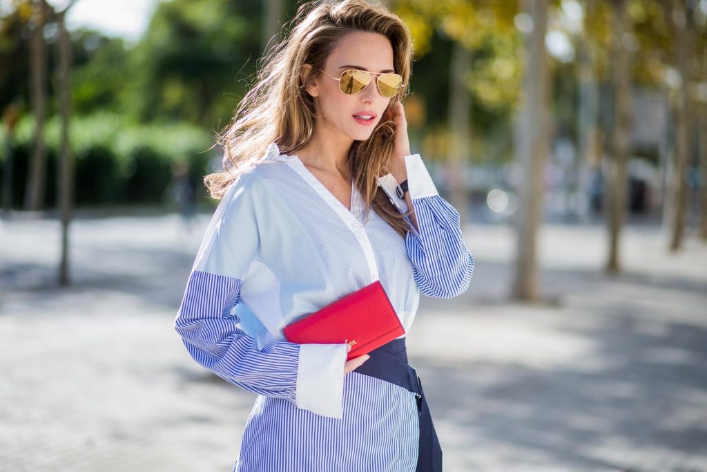 Steffen Schraut, Christian Louboutin, Ray Ban BARCELONA, SPAIN - NOVEMBER 27: Stripe Hype, Alexandra Lapp wearing a multi striped blouse with different stripes from Steffen Schraut, A-line skirt with blue and white stripes with a dark blue waist belt, So Kate pumps from Christian Louboutin in dark blue denim with a pink heel, red Christian Louboutin purse bag with golden chain, Aviator sunglasses in gold on November 27, 2017 in Barcelona, Spain.