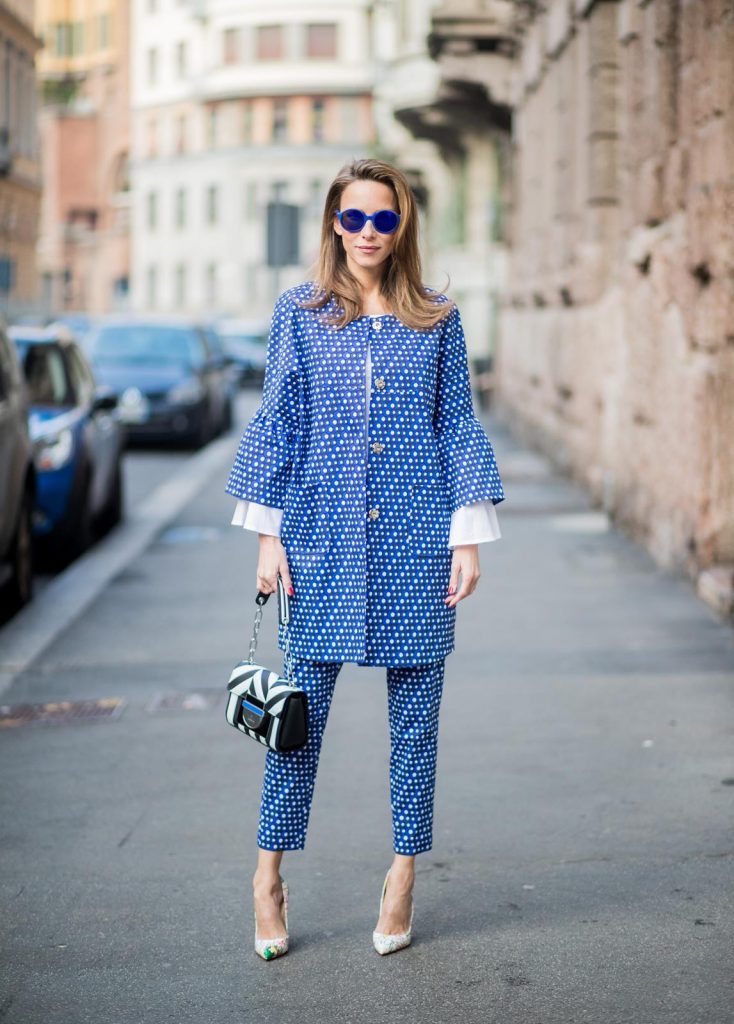 MILAN, ITALY - FEBRUARY 21: Alexandra Lapp wearing dots and stripes, blue trousers with white dots and a matching jacket with a wider short sleeve and a long white blouse from Steffen Schraut, Aigner bag, white pumps from Christian Louboutin seen during Milan Fashion Week Fall/Winter 2018/19 on February 21, 2018 in Milan, Italy.