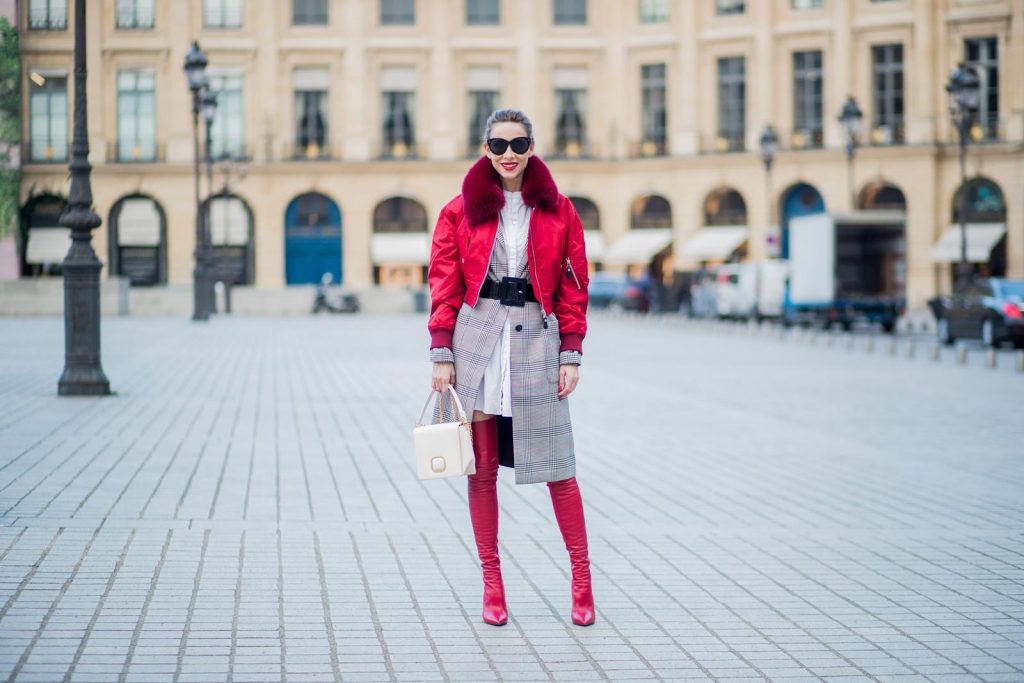 Alexandra Lapp wearing a glencheck coat from Set FAlexandra Lapp wearing a glencheck coat from Set Fashion, red leather over knee boots from Fendi, a white long shirt from Dorothee Schumacher, a black waist belt from Dolce & Gabbana, a red short bomber jacket with a dark red fur collar from Yves Salomon, off white Madame Viv bag from Roger Vivier and black sunglasses from Celine is seen on February 28, 2018 in Paris, France.