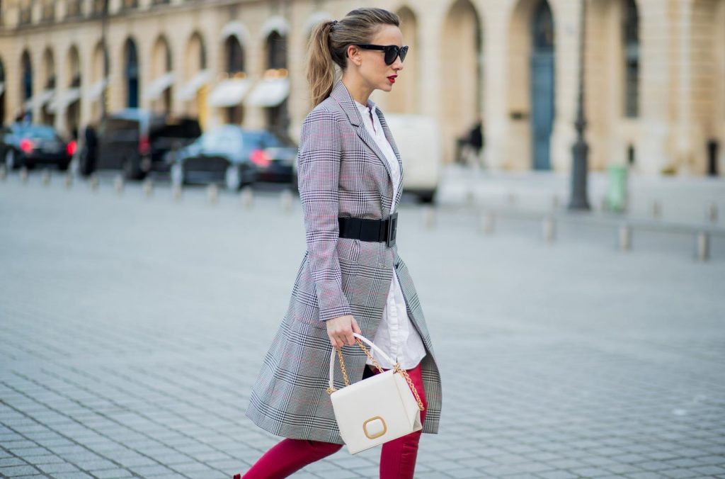 Alexandra Lapp wearing a glencheck coat from Set Fashion, red leather over knee boots from Fendi, a white long shirt from Dorothee Schumacher, a black waist belt from Dolce & Gabbana, a red short bomber jacket with a dark red fur collar from Yves Salomon, off white Madame Viv bag from Roger Vivier and black sunglasses from Celine is seen on February 28, 2018 in Paris, France.