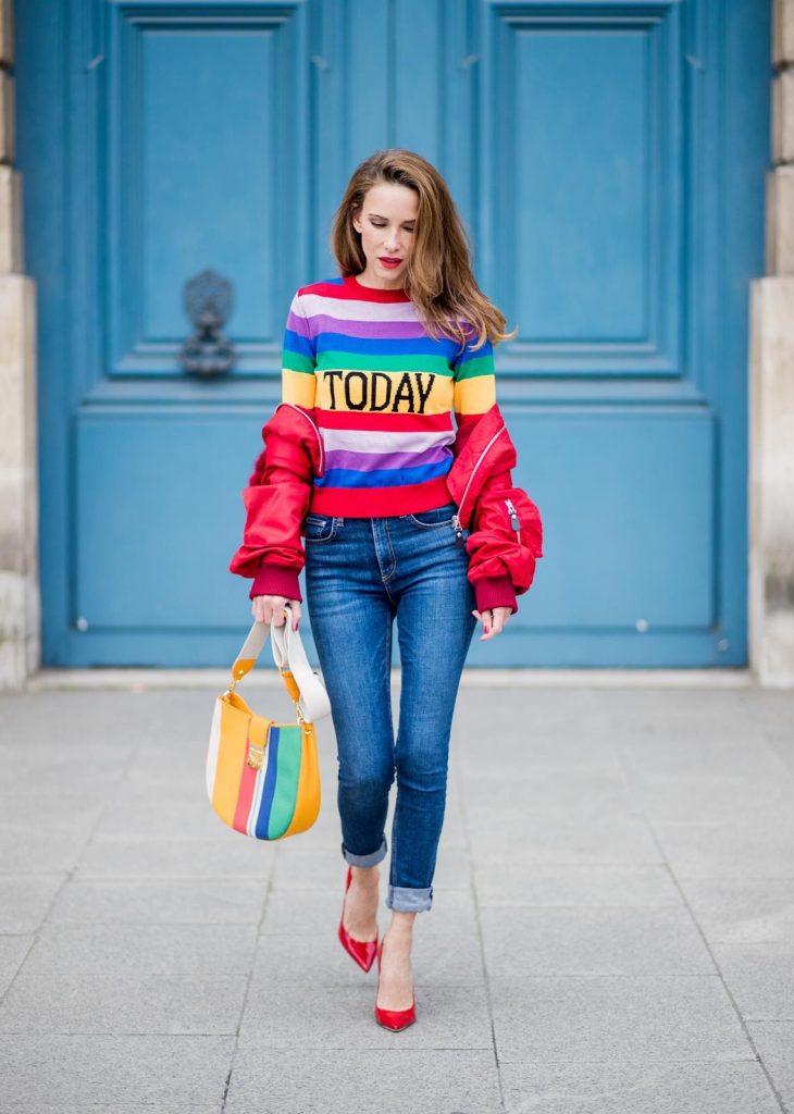 Alberta Ferretti, Yves Salomon, Adriano Goldschmied, MCM, Ray Ban, Gianvito Rossi PARIS, FRANCE - FEBRUARY 28: Alexandra Lapp wearing Pullover Alberta Ferretti with today print, AG Jeans denim, Bag MCM Patricia Hobo bag in striped Canvas, Aviator Sunglasses in green from Ray Ban, Heels Gianvito Rossi in patent red, jacket Yves Salomon is seen on February 28, 2018 in Paris, France.