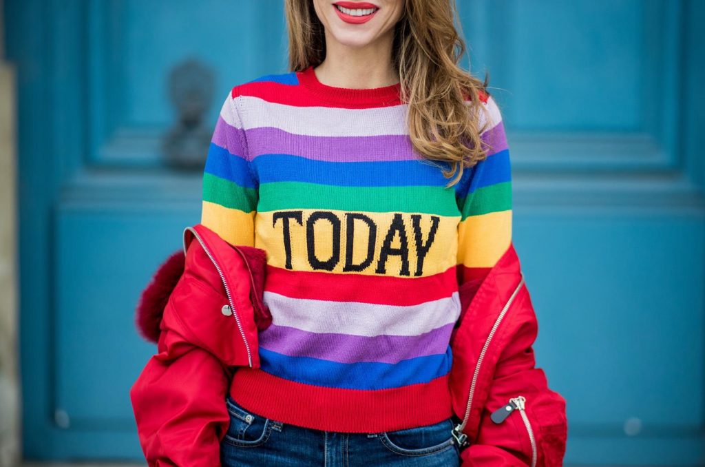 Alberta Ferretti, Yves Salomon, Adriano Goldschmied, MCM, Ray Ban, Gianvito Rossi PARIS, FRANCE - FEBRUARY 28: Alexandra Lapp wearing Pullover Alberta Ferretti with today print, AG Jeans denim, Bag MCM Patricia Hobo bag in striped Canvas, Aviator Sunglasses in green from Ray Ban, Heels Gianvito Rossi in patent red, jacket Yves Salomon is seen on February 28, 2018 in Paris, France.
