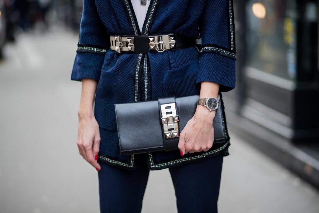 Alexandra Lapp wearing silver stitches: dark blue cropped pants and blazer shaped cardigan from Airfield, So Kate heels in patent black Christian Loubboutin, white silk top from Jadicted, bakerboy cap and pearl necklace from Chanel, Collier de Chien belt and clutch in black from Hermes, IWC watch is seen during Paris Fashion Week Womenswear Fall/Winter 2018/2019 on March 3, 2018 in Paris, France.