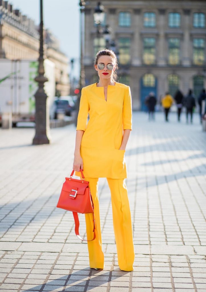 Talbot Runhof, Roger Vivier, Christian Louboutin, Le Specs Alexandra Lapp wearing taroni silk pants & a tunic in yellow from Talbot & Runhof, small Viv Cabas in orange with shoulder strap, mirrored sunglasses from Le Specs and Christian Louboutin So Kate Pumps is seen on February 28, 2018 in Paris, France.