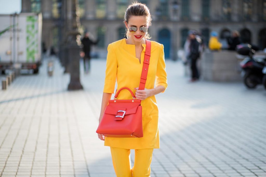 Talbot Runhof, Roger Vivier, Christian Louboutin, Le Specs Alexandra Lapp wearing taroni silk pants & a tunic in yellow from Talbot & Runhof, small Viv Cabas in orange with shoulder strap, mirrored sunglasses from Le Specs and Christian Louboutin So Kate Pumps is seen on February 28, 2018 in Paris, France.