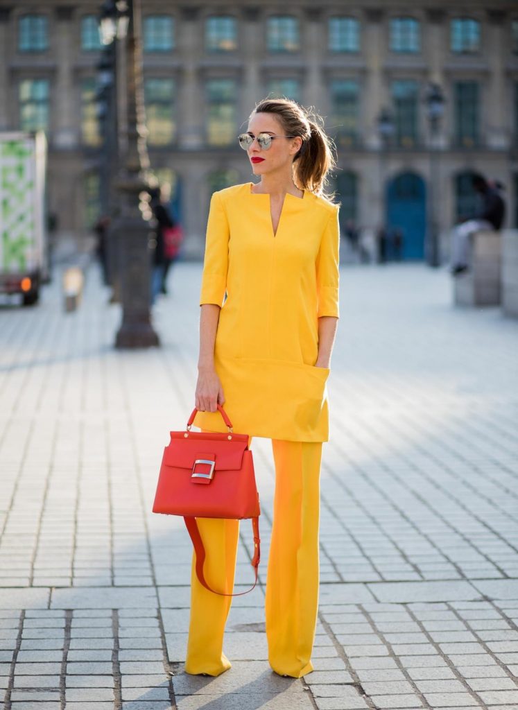 Talbot Runhof, Roger Vivier, Christian Louboutin, Le Specs Alexandra Lapp wearing taroni silk pants & a tunic in yellow from Talbot & Runhof, small Viv Cabas in orange with shoulder strap, mirrored sunglasses from Le Specs and Christian Louboutin So Kate Pumps is seen on February 28, 2018 in Paris, France.