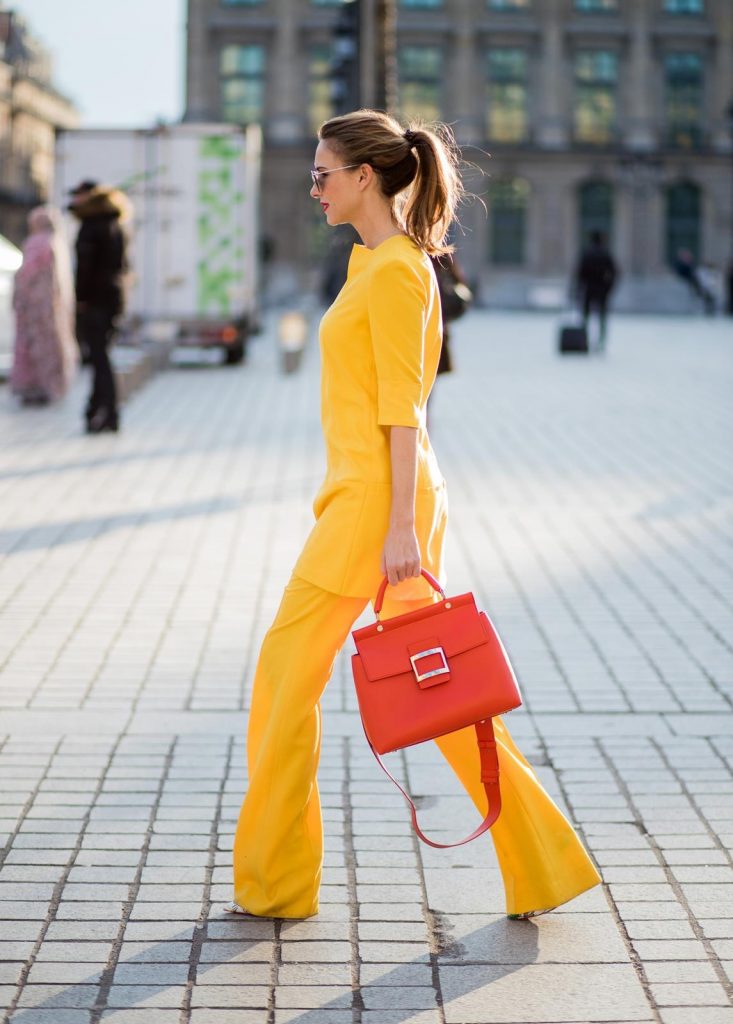Talbot Runhof, Roger Vivier, Christian Louboutin, Le Specs Alexandra Lapp wearing taroni silk pants & a tunic in yellow from Talbot & Runhof, small Viv Cabas in orange with shoulder strap, mirrored sunglasses from Le Specs and Christian Louboutin So Kate Pumps is seen on February 28, 2018 in Paris, France.