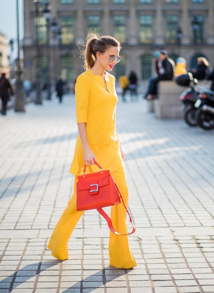 Talbot Runhof, Roger Vivier, Christian Louboutin, Le Specs Alexandra Lapp wearing taroni silk pants & a tunic in yellow from Talbot & Runhof, small Viv Cabas in orange with shoulder strap, mirrored sunglasses from Le Specs and Christian Louboutin So Kate Pumps is seen on February 28, 2018 in Paris, France.