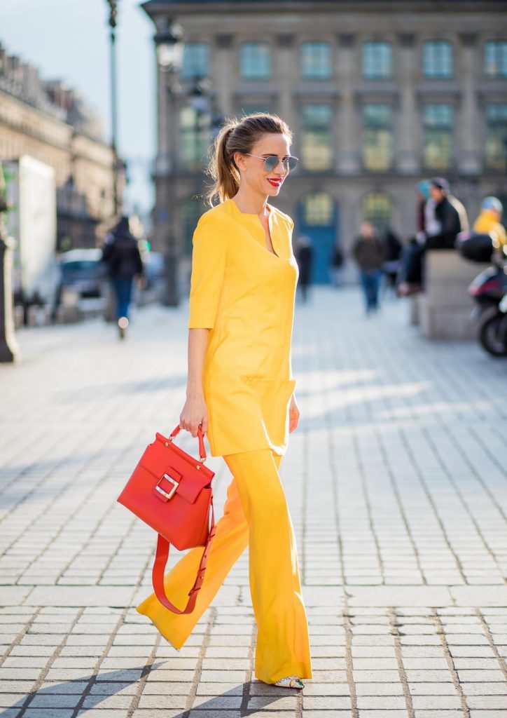 Talbot Runhof, Roger Vivier, Christian Louboutin, Le Specs Alexandra Lapp wearing taroni silk pants & a tunic in yellow from Talbot & Runhof, small Viv Cabas in orange with shoulder strap, mirrored sunglasses from Le Specs and Christian Louboutin So Kate Pumps is seen on February 28, 2018 in Paris, France.