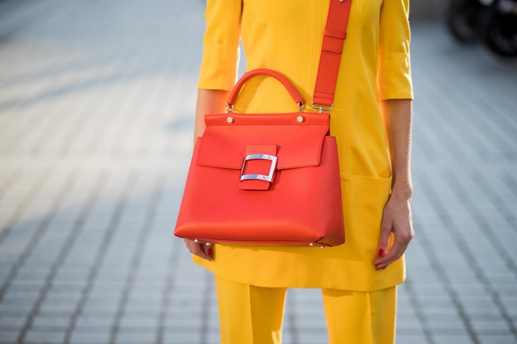Talbot Runhof, Roger Vivier, Christian Louboutin, Le Specs Alexandra Lapp wearing taroni silk pants & a tunic in yellow from Talbot & Runhof, small Viv Cabas in orange with shoulder strap, mirrored sunglasses from Le Specs and Christian Louboutin So Kate Pumps is seen on February 28, 2018 in Paris, France.