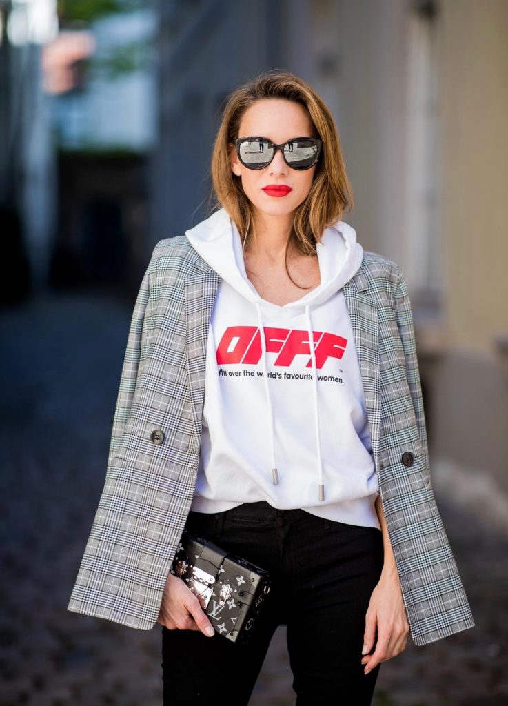 Off-White, Anine Bing, Mother, Christian Louboutin, Louis Vuitton, Dior Alexandra Lapp wearing the Off-White Hoodie c/o Virgil Abloh 0777 cotton Terry Hoodie in white, multicolored plaid Madeleine blazer by Anine Bing, the Cha Cha Fray flared pants in black by Mother, black patent leather pumps by Christian Louboutin, a black Petite Malle with silver accessories by Louis Vuitton and black Diormania sunglasses by Dior on May 6, 2018 in Duesseldorf, Germany.