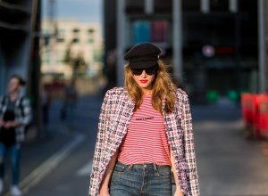 Alexandra Lapp wearing a striped shirt look with Saint Laurent Logo jersey T-Shirt in red-white, a white/blue/red Tweed Jacket by Balmain, dark blue Levis Super Skinny jeans, Prada flame shoes, the Chanel Perfume Bottle Bag in clear plexiglass, vintage Chanel Bakerboy cap and black Celine sunglasses on May 3, 2018 in Duesseldorf, Germany.