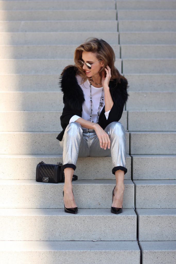 Airfield, Chanel, Le Specs, Jadicted, Christian Louboutin Model and Blogger Alexandra Lapp wearing silver denim pants from Airfield, black knit and fur cape from Airfield, black Boy Bag from Chanel, Chanel vintage necklace, silver sunglasses by Le Specs, white silk shirt from Jades and black lacquer Pigalle pumps from Christian Louboutin.