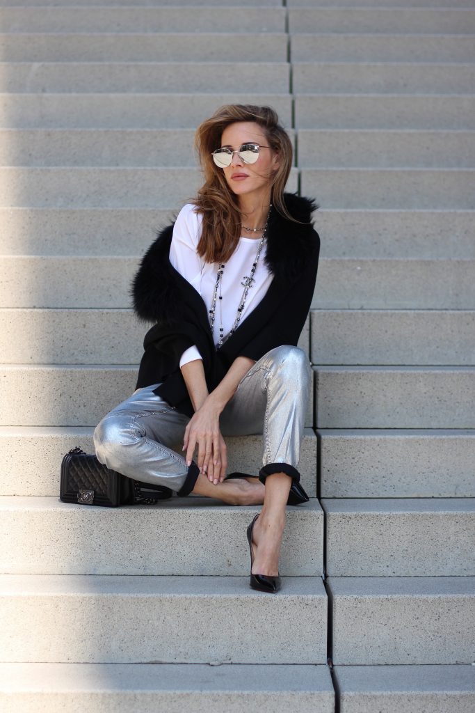 Airfield, Chanel, Le Specs, Jadicted, Christian Louboutin Model and Blogger Alexandra Lapp wearing silver denim pants from Airfield, black knit and fur cape from Airfield, black Boy Bag from Chanel, Chanel vintage necklace, silver sunglasses by Le Specs, white silk shirt from Jades and black lacquer Pigalle pumps from Christian Louboutin.