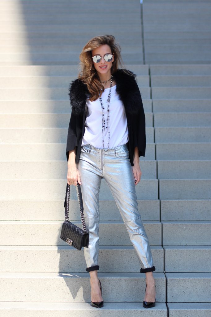 Airfield, Chanel, Le Specs, Jadicted, Christian Louboutin Model and Blogger Alexandra Lapp wearing silver denim pants from Airfield, black knit and fur cape from Airfield, black Boy Bag from Chanel, Chanel vintage necklace, silver sunglasses by Le Specs, white silk shirt from Jades and black lacquer Pigalle pumps from Christian Louboutin.