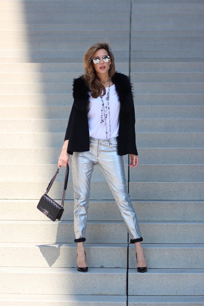 Airfield, Chanel, Le Specs, Jadicted, Christian Louboutin Model and Blogger Alexandra Lapp wearing silver denim pants from Airfield, black knit and fur cape from Airfield, black Boy Bag from Chanel, Chanel vintage necklace, silver sunglasses by Le Specs, white silk shirt from Jades and black lacquer Pigalle pumps from Christian Louboutin.