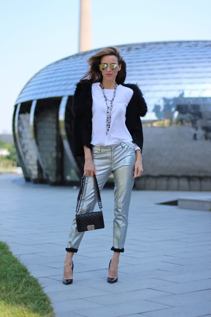 Airfield, Chanel, Le Specs, Jadicted, Christian Louboutin Model and Blogger Alexandra Lapp wearing silver denim pants from Airfield, black knit and fur cape from Airfield, black Boy Bag from Chanel, Chanel vintage necklace, silver sunglasses by Le Specs, white silk shirt from Jades and black lacquer Pigalle pumps from Christian Louboutin.