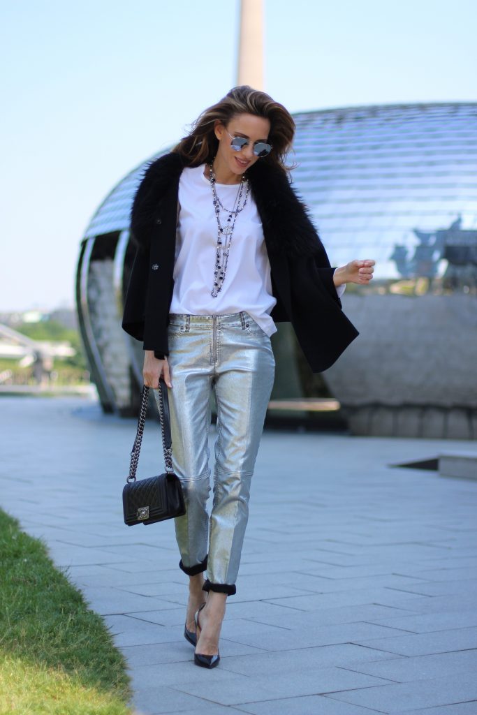 Airfield, Chanel, Le Specs, Jadicted, Christian Louboutin Model and Blogger Alexandra Lapp wearing silver denim pants from Airfield, black knit and fur cape from Airfield, black Boy Bag from Chanel, Chanel vintage necklace, silver sunglasses by Le Specs, white silk shirt from Jades and black lacquer Pigalle pumps from Christian Louboutin.