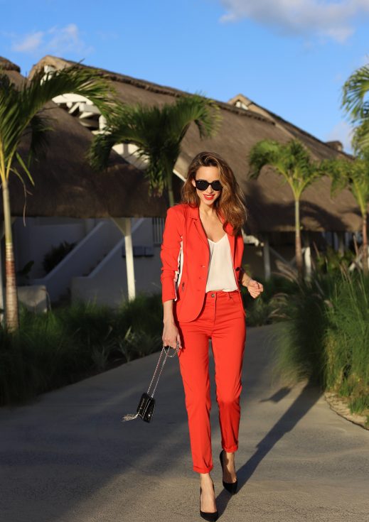 Model & Blogger Alexandra Lapp in Red Vibes wearing a red suit from Airfield, a white silk top from Jadicted, Christian Louboutin black suede pumps, a small Kate Tassel Yves Saint Laurent handbag in black and black Céline sunglasses.