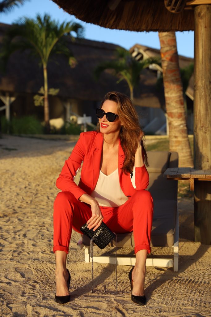 Airfield, Jadicted, Christian Louboutin, Saint Laurent, Céline Model & Blogger Alexandra Lapp in Red Vibes wearing a red suit from Airfield, a white silk top from Jadicted, Christian Louboutin black suede pumps, a small Kate Tassel Yves Saint Laurent handbag in black and black Céline sunglasses.