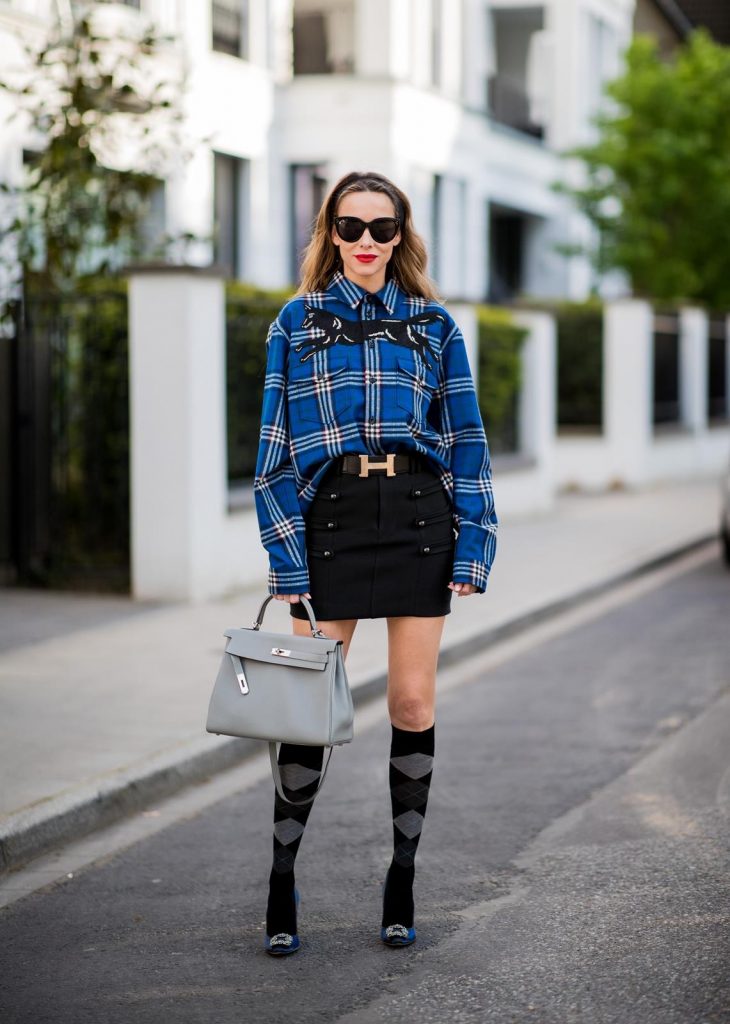 Alexandra Lapp in a Burlington Socks | Hairband Style wearing a blue embroidered check shirt by Gucci, a black wool skirt by Isabel Marant, blue Hangisi satin Manolo Blahnik pumps, grey black knee-high Burlington socks, a grey Hermes Birkin bag, a vintage black Hermes belt and black Celine sunglasses on May 3, 2018 in Duesseldorf, Germany.
