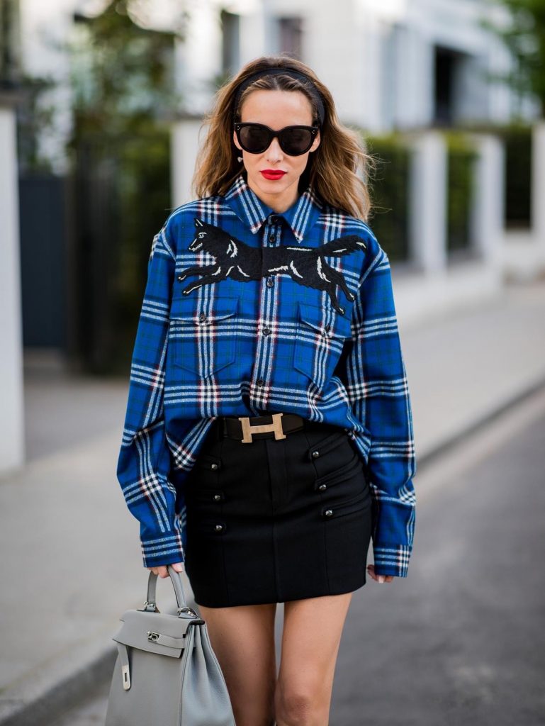 Alexandra Lapp in a Burlington Socks | Hairband Style wearing a blue embroidered check shirt by Gucci, a black wool skirt by Isabel Marant, blue Hangisi satin Manolo Blahnik pumps, grey black knee-high Burlington socks, a grey Hermes Birkin bag, a vintage black Hermes belt and black Celine sunglasses on May 3, 2018 in Duesseldorf, Germany.
