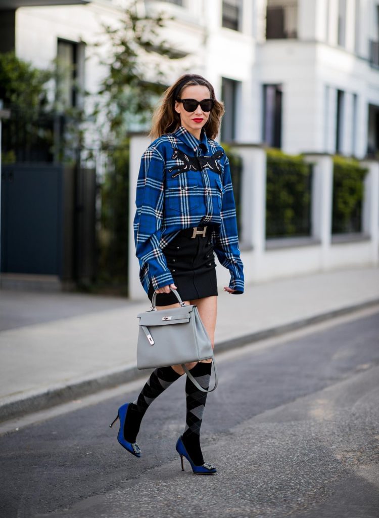 Alexandra Lapp in a Burlington Socks | Hairband Style wearing a blue embroidered check shirt by Gucci, a black wool skirt by Isabel Marant, blue Hangisi satin Manolo Blahnik pumps, grey black knee-high Burlington socks, a grey Hermes Birkin bag, a vintage black Hermes belt and black Celine sunglasses on May 3, 2018 in Duesseldorf, Germany.