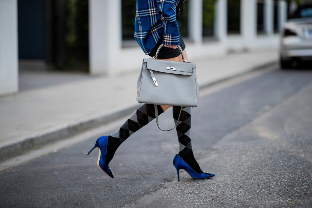 Alexandra Lapp in a Burlington Socks | Hairband Style wearing a blue embroidered check shirt by Gucci, a black wool skirt by Isabel Marant, blue Hangisi satin Manolo Blahnik pumps, grey black knee-high Burlington socks, a grey Hermes Birkin bag, a vintage black Hermes belt and black Celine sunglasses on May 3, 2018 in Duesseldorf, Germany.