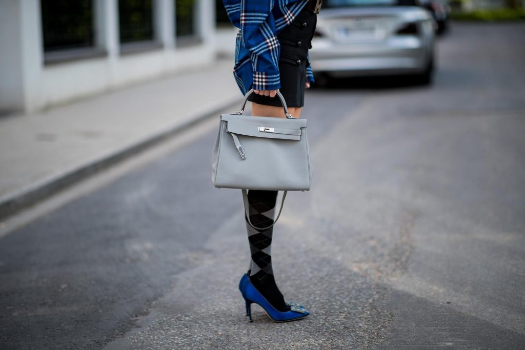 Alexandra Lapp in a Burlington Socks | Hairband Style wearing a blue embroidered check shirt by Gucci, a black wool skirt by Isabel Marant, blue Hangisi satin Manolo Blahnik pumps, grey black knee-high Burlington socks, a grey Hermes Birkin bag, a vintage black Hermes belt and black Celine sunglasses on May 3, 2018 in Duesseldorf, Germany.
