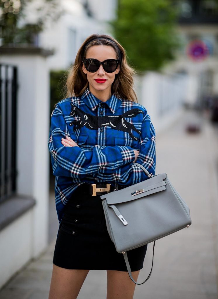 Alexandra Lapp in a Burlington Socks | Hairband Style wearing a blue embroidered check shirt by Gucci, a black wool skirt by Isabel Marant, blue Hangisi satin Manolo Blahnik pumps, grey black knee-high Burlington socks, a grey Hermes Birkin bag, a vintage black Hermes belt and black Celine sunglasses on May 3, 2018 in Duesseldorf, Germany.