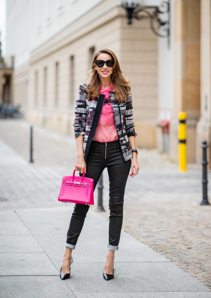 Alexandra Lapp in Birkin Bag Mini Look wearing a short checked colorful jacket with zipper from Airfield, transparent pink blouse with a big flower around the neck from Gucci, black Jeggins by Airfield, Dior slingback pumps in black with a J adior ribbon, a pink mini Birkin bag from Hermes, black Celine sunglasses and IWC watch during the Berlin Fashion Week July 2018 on July 6, 2018 in Berlin, Germany.