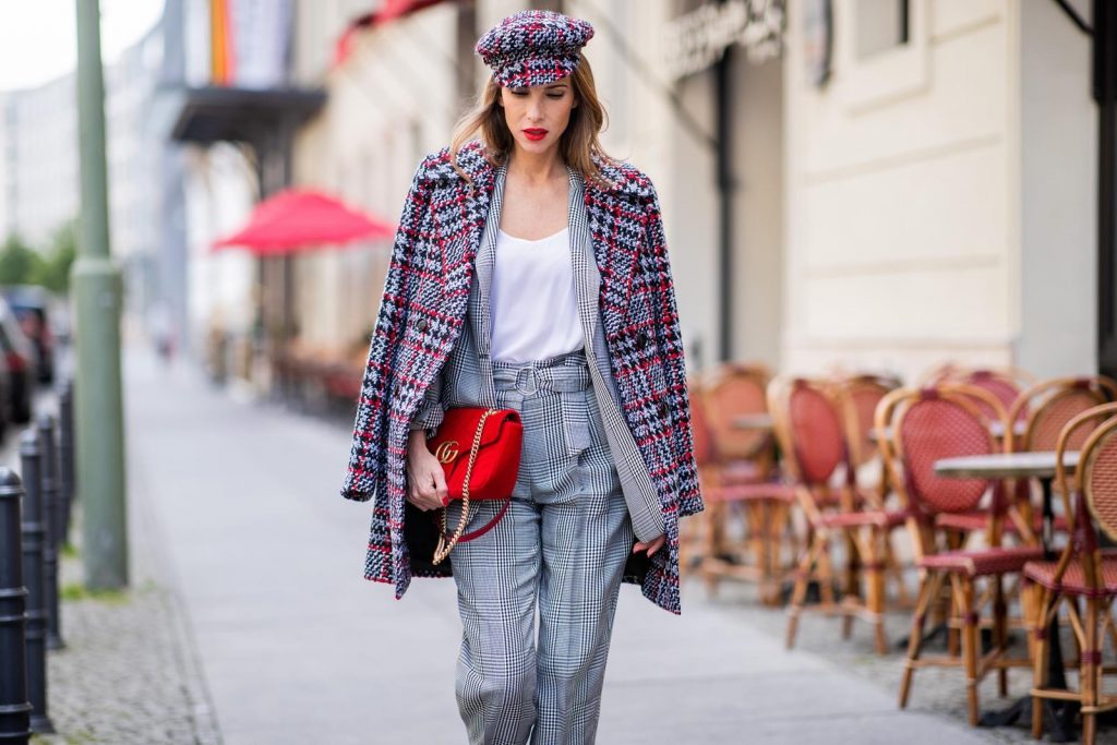 Alexandra Lapp for Big Dream | Riani wearing a checkered suit combination in black and white with a long blazer and high waist pants with an integrated belt both from Riani, a white silk top from Jadicted, red lacquer Gianvito Rossi pumps, red velvet GG Marmont Gucci handbag, vintage Gucci sunglasses and an IWC watch during the Berlin Fashion Week July 2018 on July 6, 2018 in Berlin, Germany.