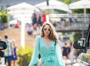 Alexandra Lapp in a turquoise dress wearing a long shine through dress in turquoise by Lana Mueller, a 2.55 silver handbag by Chanel, two tone Manolo Blahnik heels in silver turquoise and white Victoire sunglasses by Saint Laurent seen outside Lana Mueller during the Berlin Fashion Week July 2018 on July 5, 2018 in Berlin, Germany.