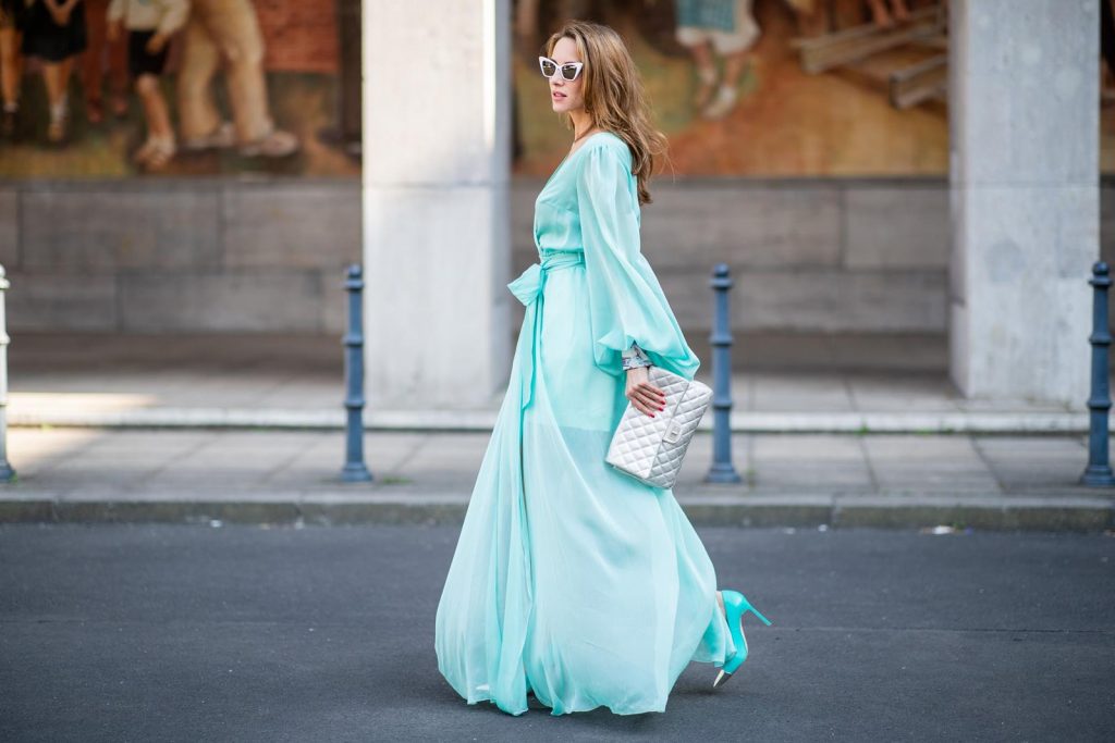 Alexandra Lapp in a turquoise dress wearing a long shine through dress in turquoise by Lana Mueller, a 2.55 silver handbag by Chanel, two tone Manolo Blahnik heels in silver turquoise and white Victoire sunglasses by Saint Laurent seen outside Lana Mueller during the Berlin Fashion Week July 2018 on July 5, 2018 in Berlin, Germany.