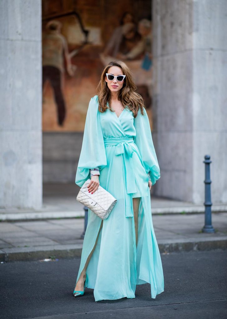 Alexandra Lapp in a turquoise dress wearing a long shine through dress in turquoise by Lana Mueller, a 2.55 silver handbag by Chanel, two tone Manolo Blahnik heels in silver turquoise and white Victoire sunglasses by Saint Laurent seen outside Lana Mueller during the Berlin Fashion Week July 2018 on July 5, 2018 in Berlin, Germany.