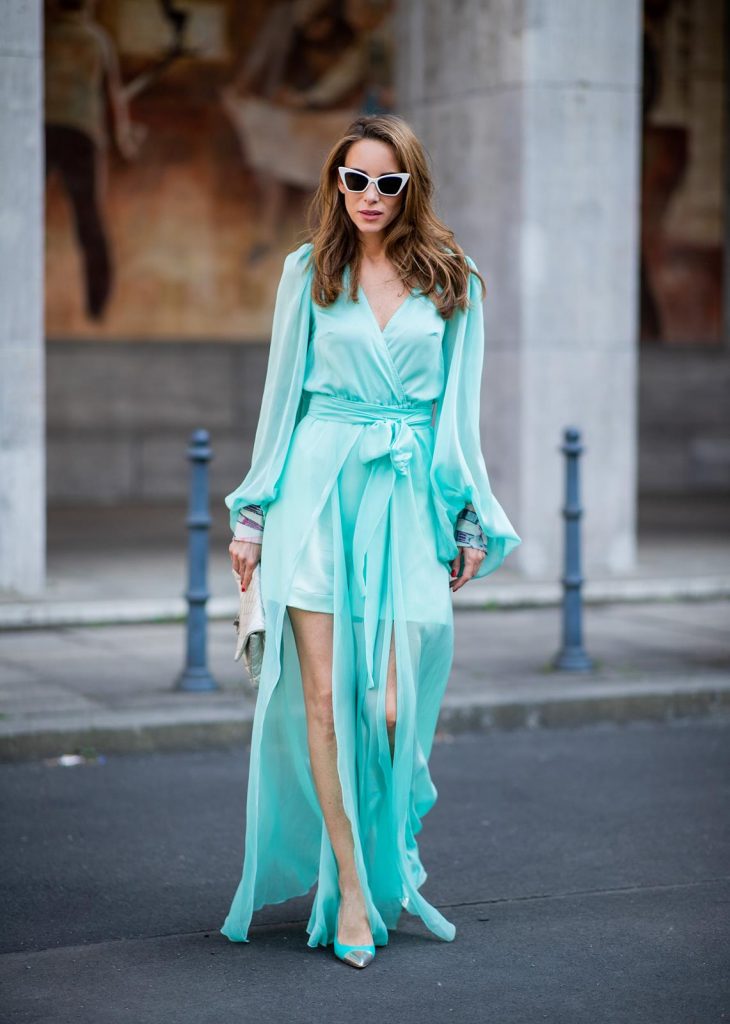 Alexandra Lapp in a turquoise dress wearing a long shine through dress in turquoise by Lana Mueller, a 2.55 silver handbag by Chanel, two tone Manolo Blahnik heels in silver turquoise and white Victoire sunglasses by Saint Laurent seen outside Lana Mueller during the Berlin Fashion Week July 2018 on July 5, 2018 in Berlin, Germany.