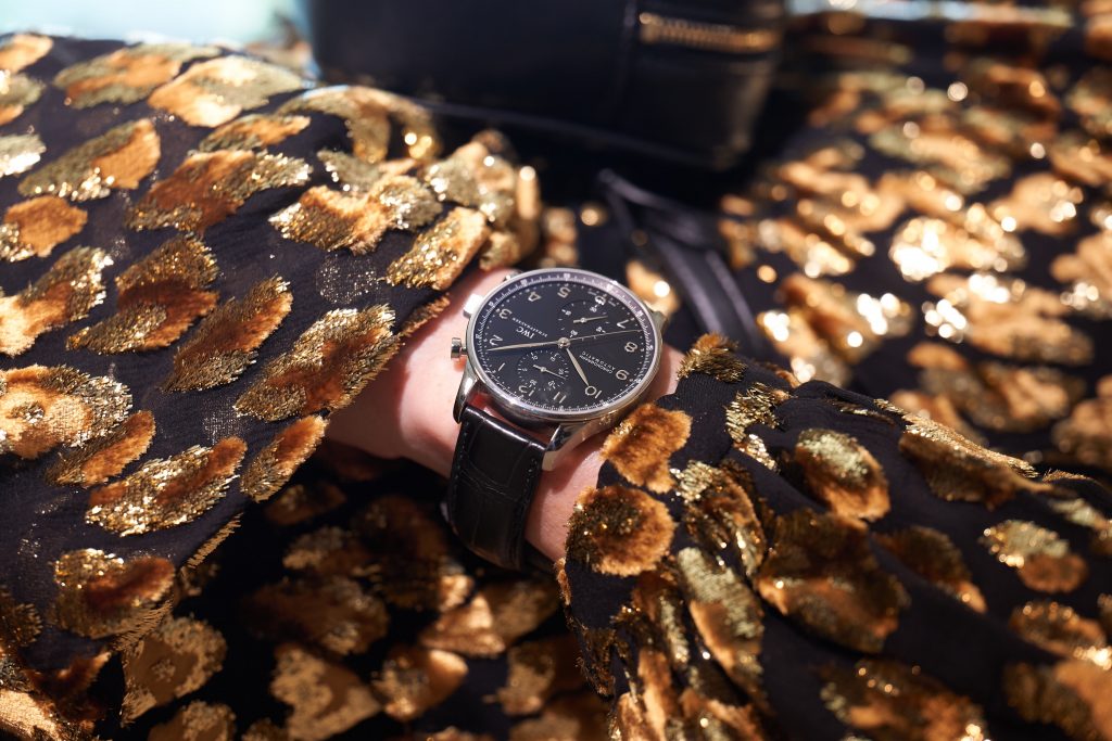 Model and Blogger Alexandra Lapp in an Animal Print Look wearing a leopard patterned jumpsuit in gold metallic by Maison Valentino, the Lou Camera Leather Crossbody Bag in black from Saint Laurent, Pigalle Follies 100 metallic crinkled leather Pumps in gold by Christian Louboutin and the Portugieser Chronograph watch by IWC.