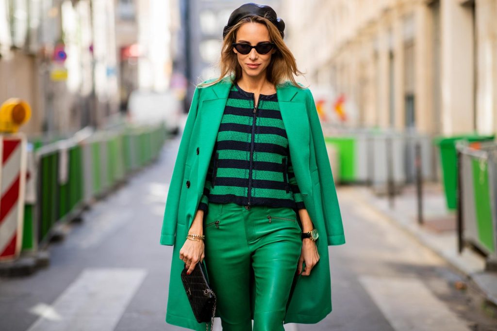 Alexandra Lapp in a Go Green Look wearing green skinny Riani leather pants, black green striped knit with a zipper by Riani, a green oversized blazer jacket by Riani, a black Chanel 2.55 flap bag, black suede Christian Louboutin high heels, cat-eye shaped Isabella Sunglasses by illesteva and a black Eugenia Kim beret during Paris Fashion Week Womenswear Spring/Summer 2019 on September 27, 2018 in Paris, France.