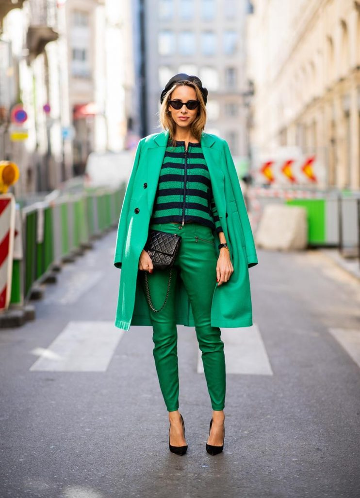Alexandra Lapp in a Go Green Look wearing green skinny Riani leather pants, black green striped knit with a zipper by Riani, a green oversized blazer jacket by Riani, a black Chanel 2.55 flap bag, black suede Christian Louboutin high heels, cat-eye shaped Isabella Sunglasses by illesteva and a black Eugenia Kim beret during Paris Fashion Week Womenswear Spring/Summer 2019 on September 27, 2018 in Paris, France.