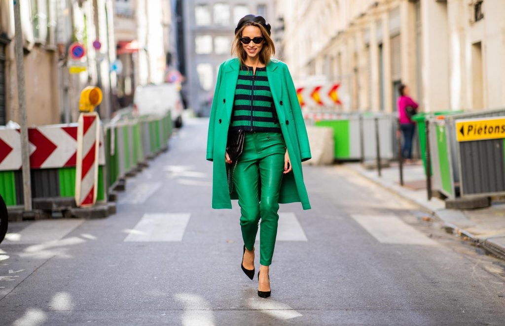 Alexandra Lapp in a Go Green Look wearing green skinny Riani leather pants, black green striped knit with a zipper by Riani, a green oversized blazer jacket by Riani, a black Chanel 2.55 flap bag, black suede Christian Louboutin high heels, cat-eye shaped Isabella Sunglasses by illesteva and a black Eugenia Kim beret during Paris Fashion Week Womenswear Spring/Summer 2019 on September 27, 2018 in Paris, France.