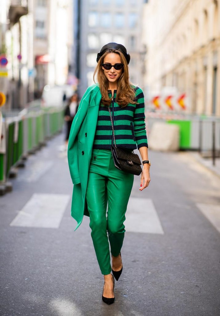 Alexandra Lapp in a Go Green Look wearing green skinny Riani leather pants, black green striped knit with a zipper by Riani, a green oversized blazer jacket by Riani, a black Chanel 2.55 flap bag, black suede Christian Louboutin high heels, cat-eye shaped Isabella Sunglasses by illesteva and a black Eugenia Kim beret during Paris Fashion Week Womenswear Spring/Summer 2019 on September 27, 2018 in Paris, France.